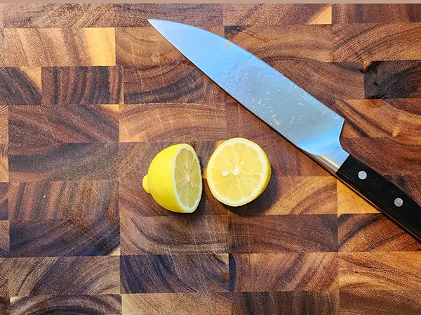Lemon cutted in half on the wooden board