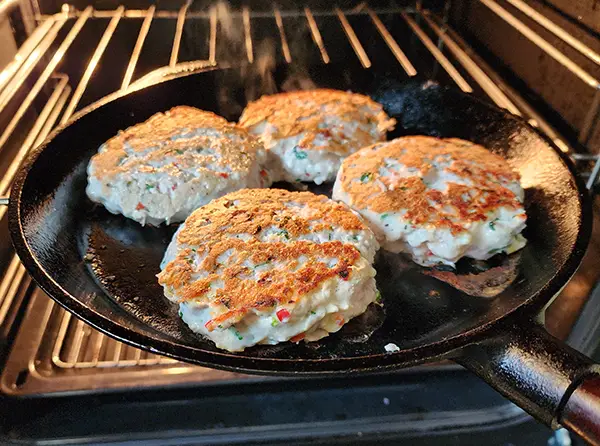 Putting turkey patties into the oven