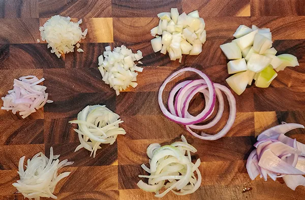 10 ways of sliced onions on the wooden board. How to cut onions.