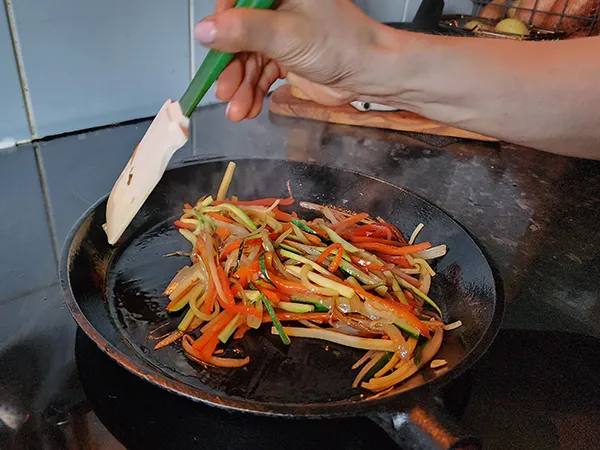 Mixing sliced vegetables with the spatula