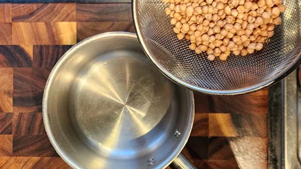 Putting chickpeas in a pot
