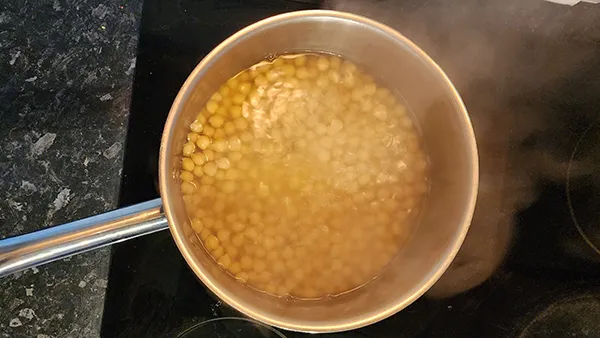 Simmering chickpeas in a pot