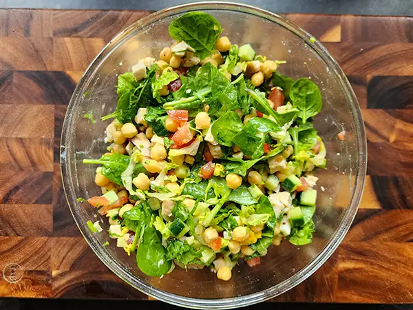 Mixing chicken chickpea salad