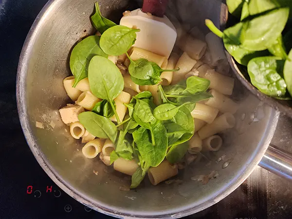 Adding pasta to the mushrooms