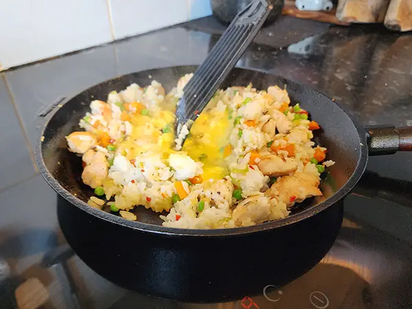 Adding egg to the chicken fried rice