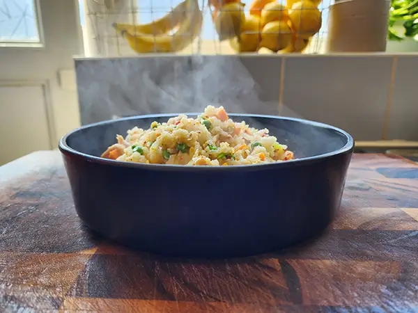 Serving chicken fried rice into a bowl