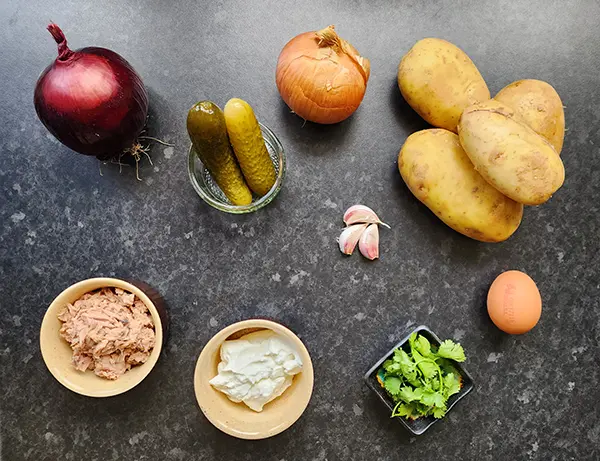 Ingredients for tghe potato pancakes on the wooden board