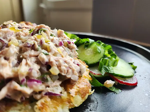 Potato pancakes served on the plate with tuna salad