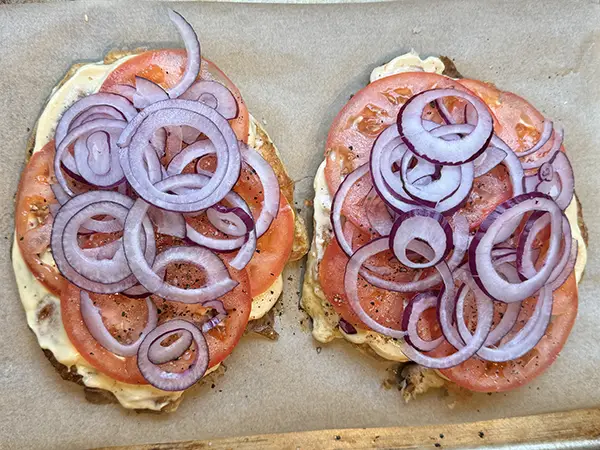 Adding tomatoes and red onions